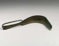 A Greek bronze strigil